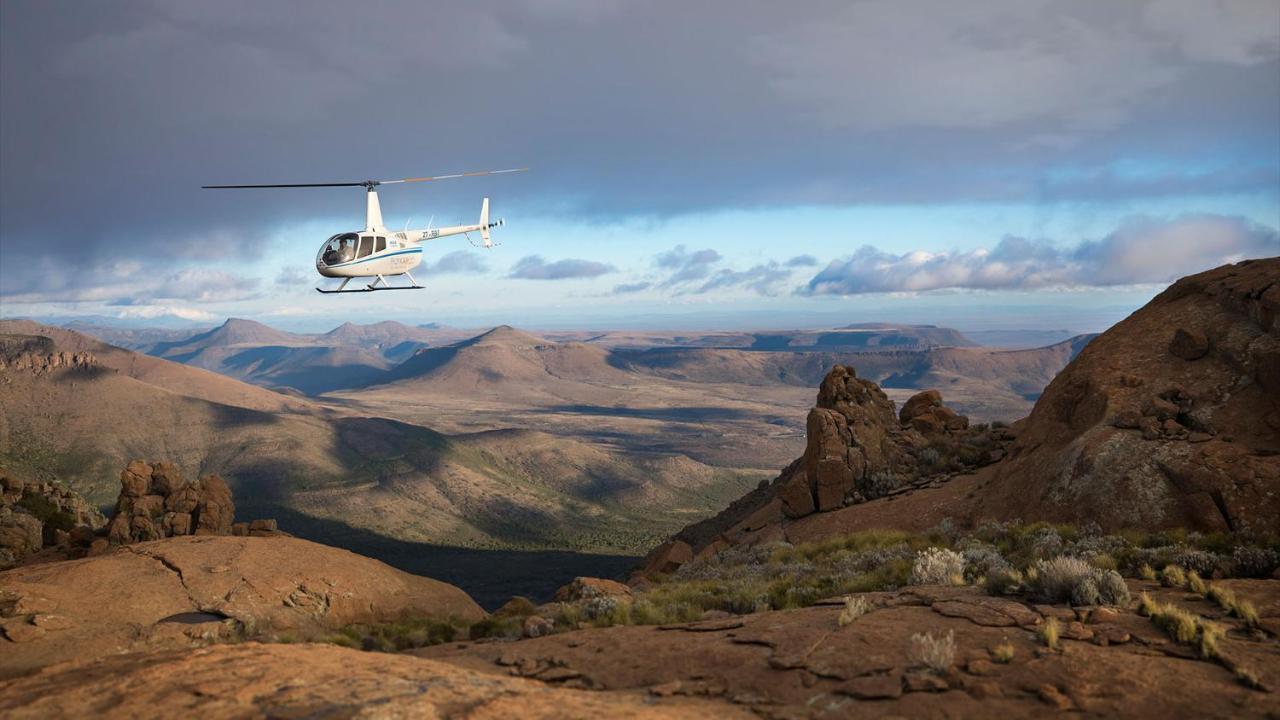 Drostdy Hotel Graaff-Reinet Екстериор снимка A Robinson R44 helicopter flying over the Namib Desert